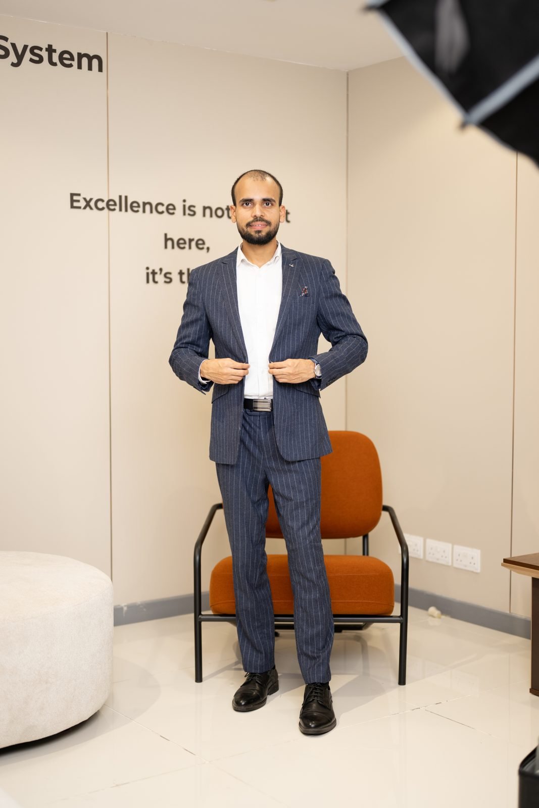 Shahbaz Khan in a navy suit